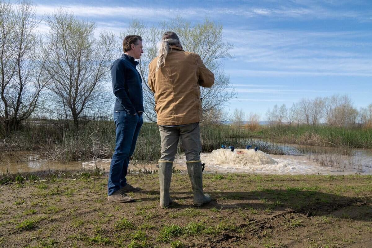 Gov. Gavin Newsom tours Brian and Elena Corral’s 810 acres of Dunnigan farmland in March 2023 to observe how recycled collected water is being used to flood the property to recharge Yolo County’s groundwater aquifer. Newsom announced an end to some of the water restrictions implemented during the drought of the previous years.